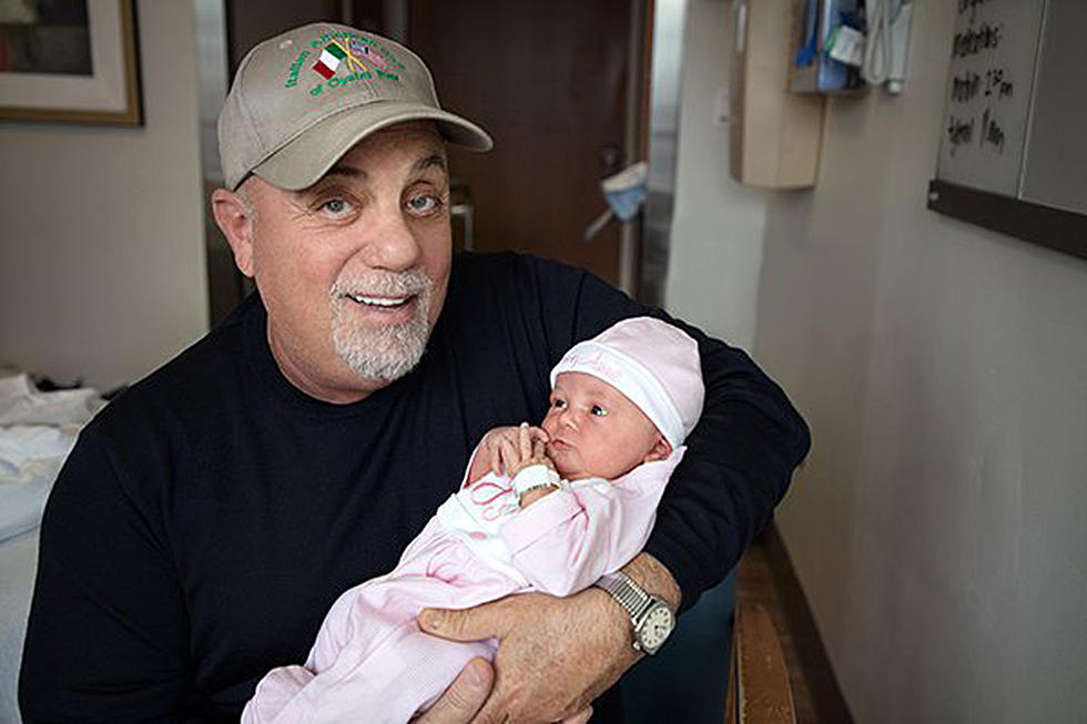 Billy Joel holding daughter Remy Anne