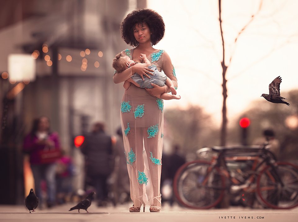 Mother breastfeeding her baby on the street
