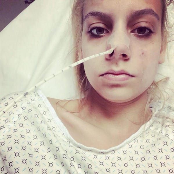 Bekah Georgy lying in a hospital bed