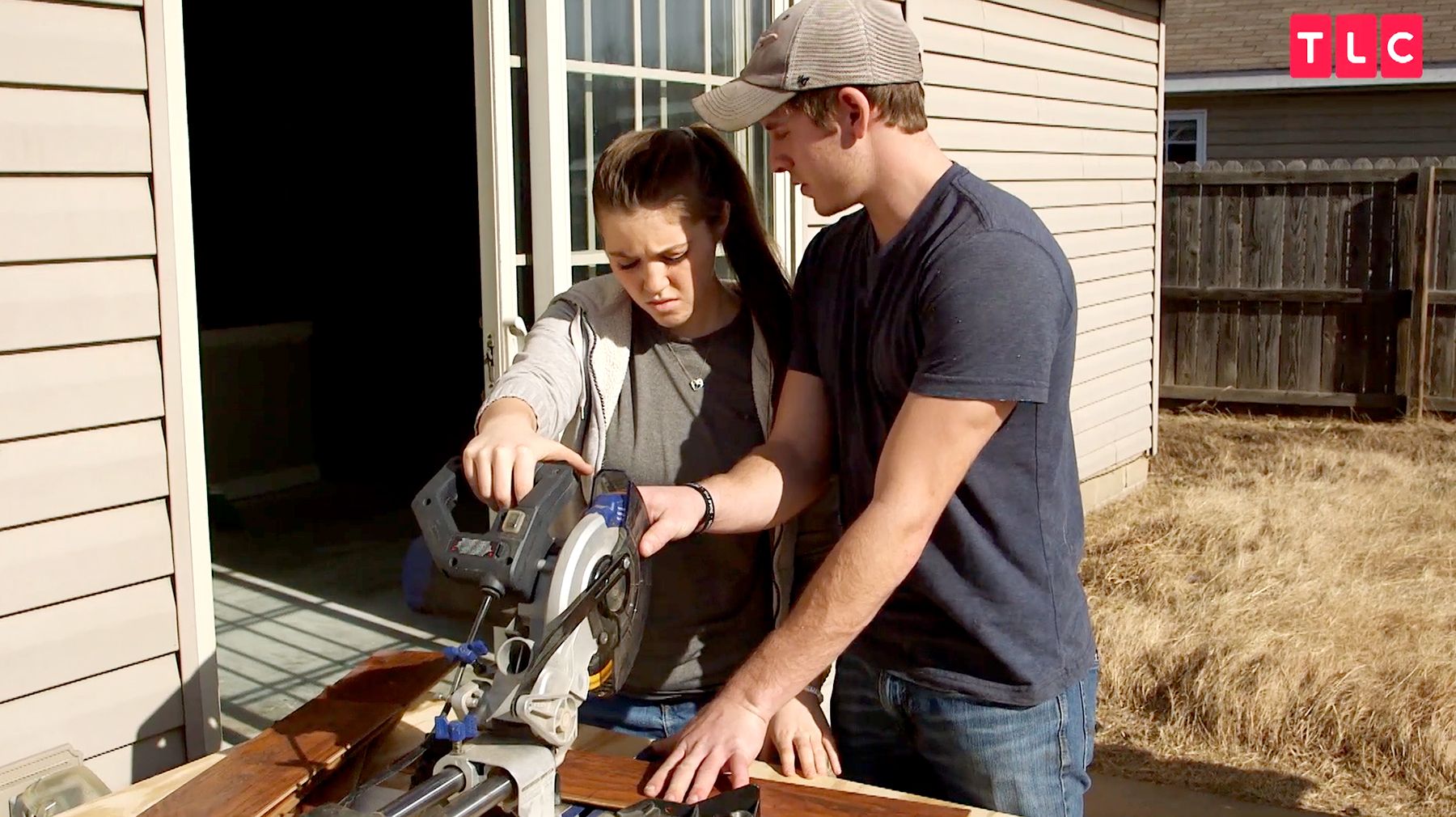 Joy-Anna and Austin sawing