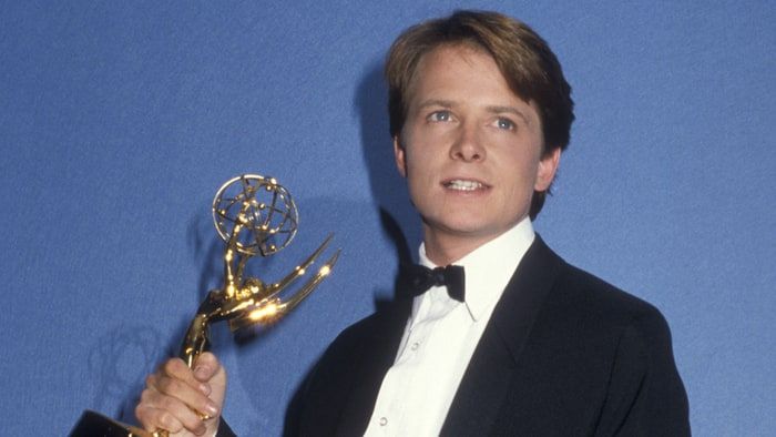 Michael J. Fox holding an Emmy Award