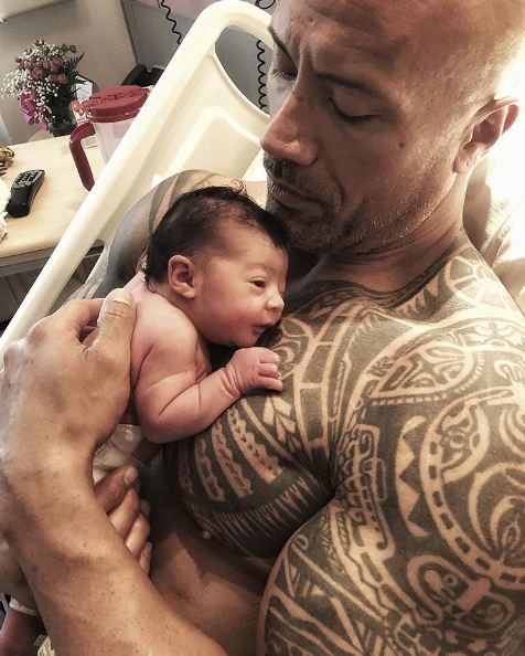 The Rock and his newborn daughter cuddling