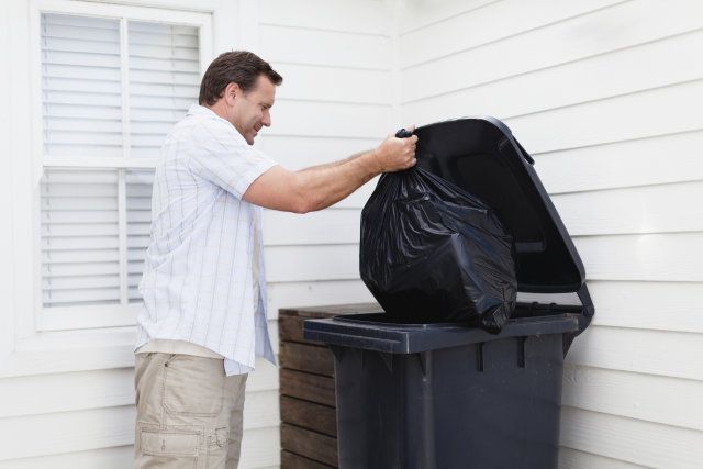 A man throwing out garbage