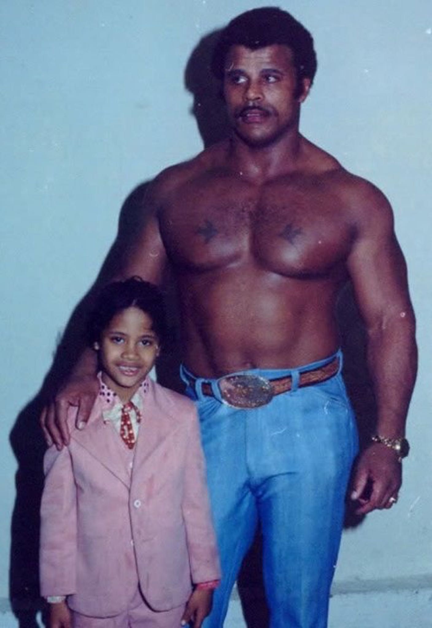 A young Dwayne Johnson with his dad Rocky