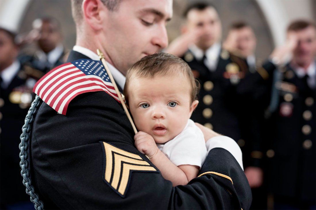 A soldier holding the baby