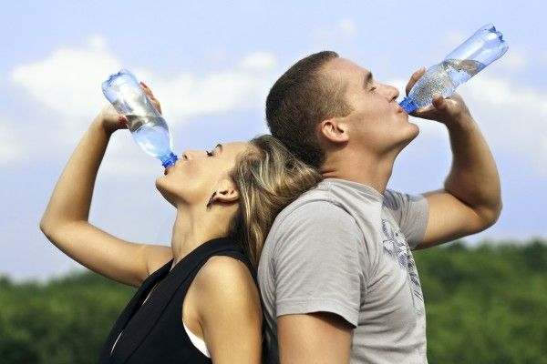 Two people drinking water