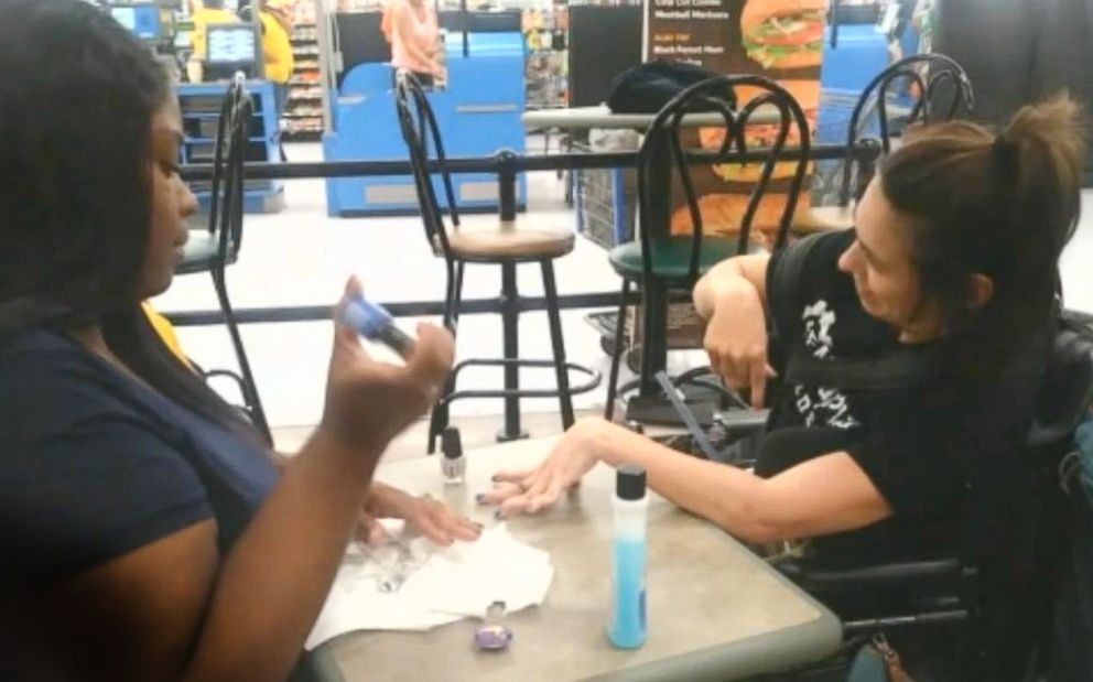 Ebony Harris painting Angela Harris' nails