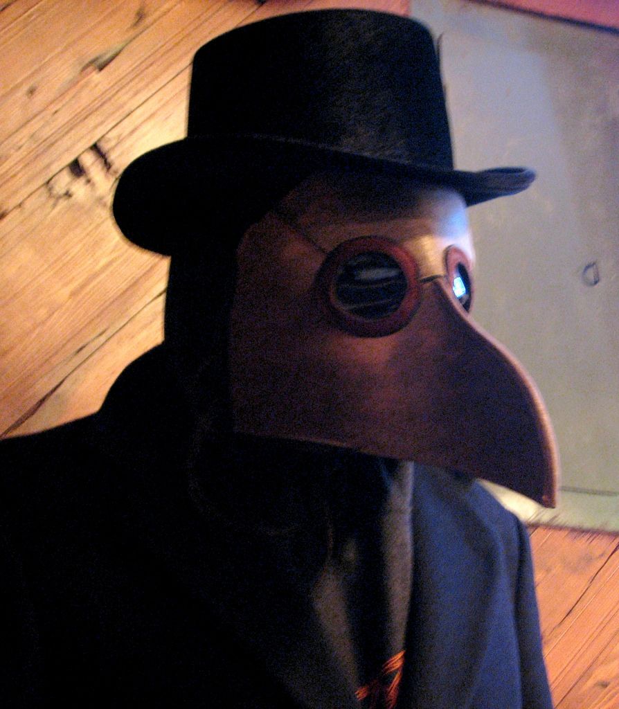 Plague doctor wearing a beaked maska