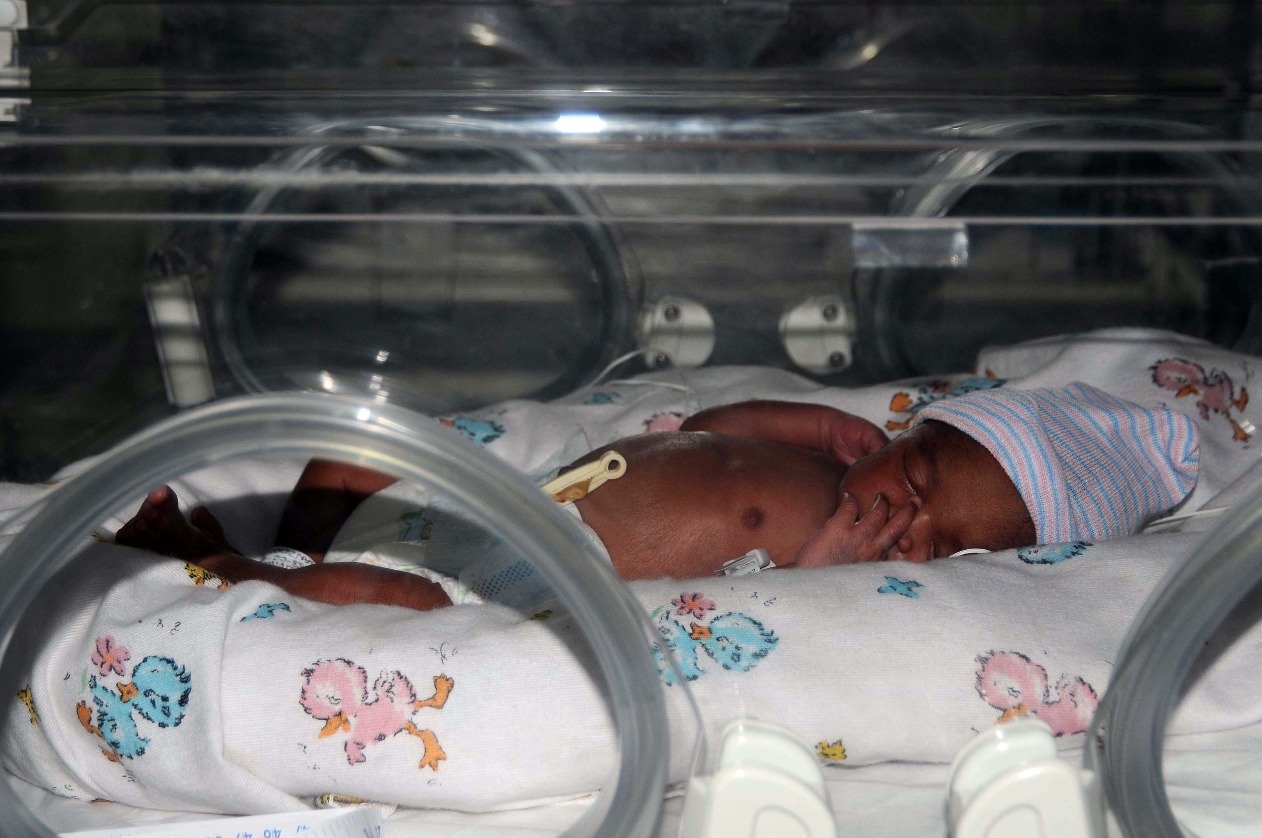 Newborn baby sleeping in incubator. 