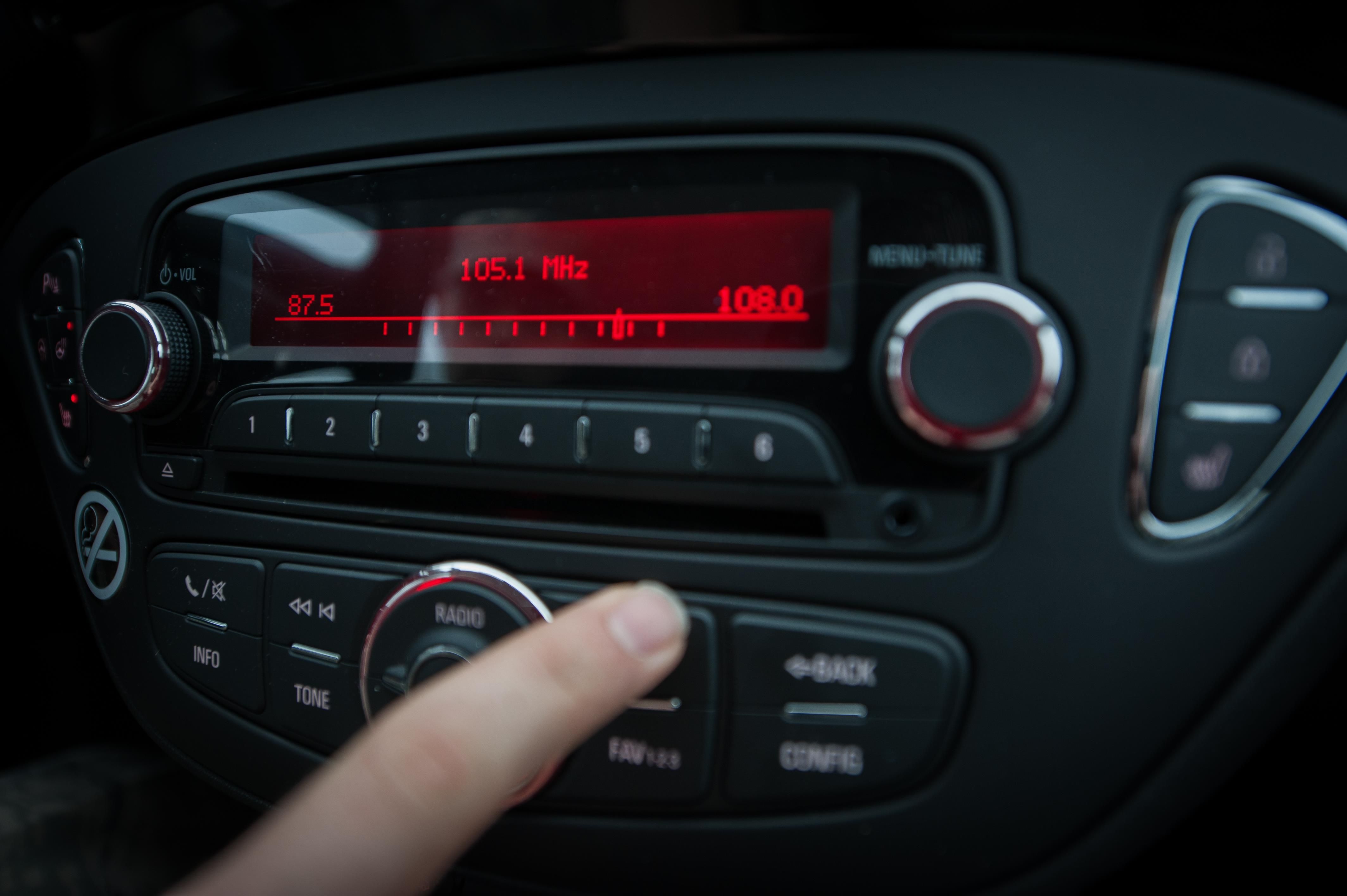 A finger on the car radio