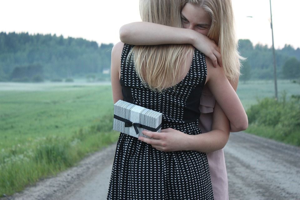 Women hugging after giving a gift