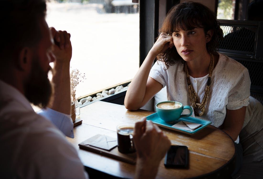 Couple talking in coffee shop