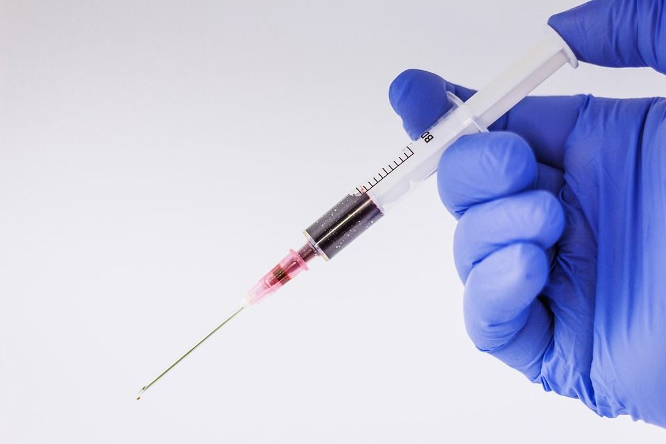 Needle with gloved hand