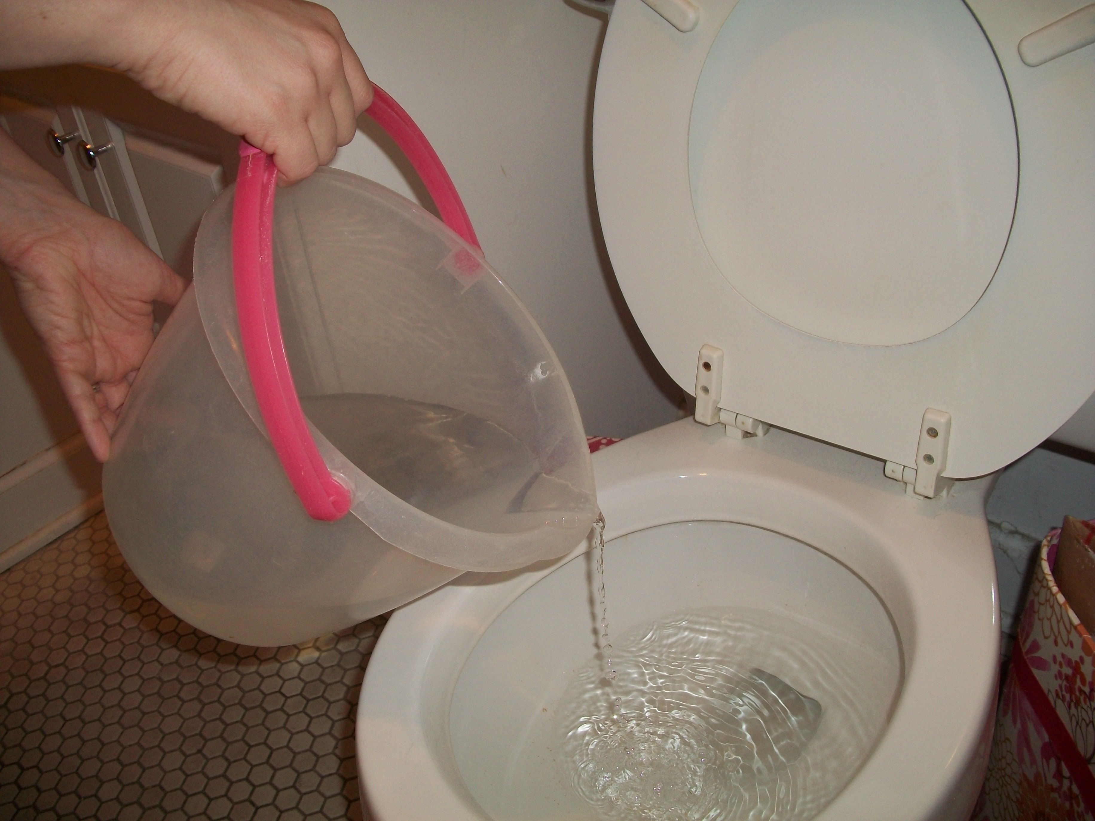 Pouring water into the toilet