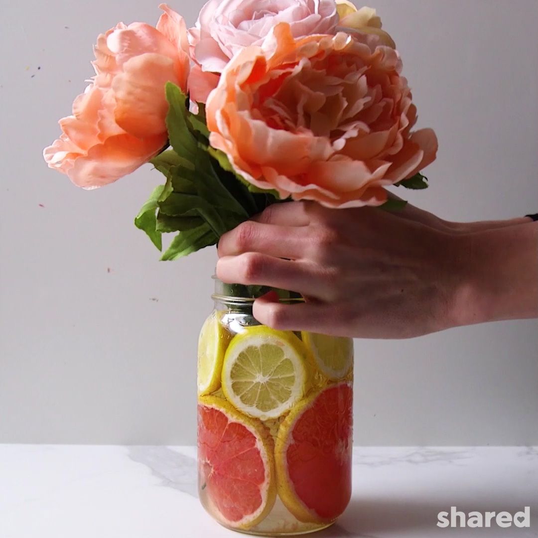 peach peonie  flowers in  citrus lined flower vase by Shared