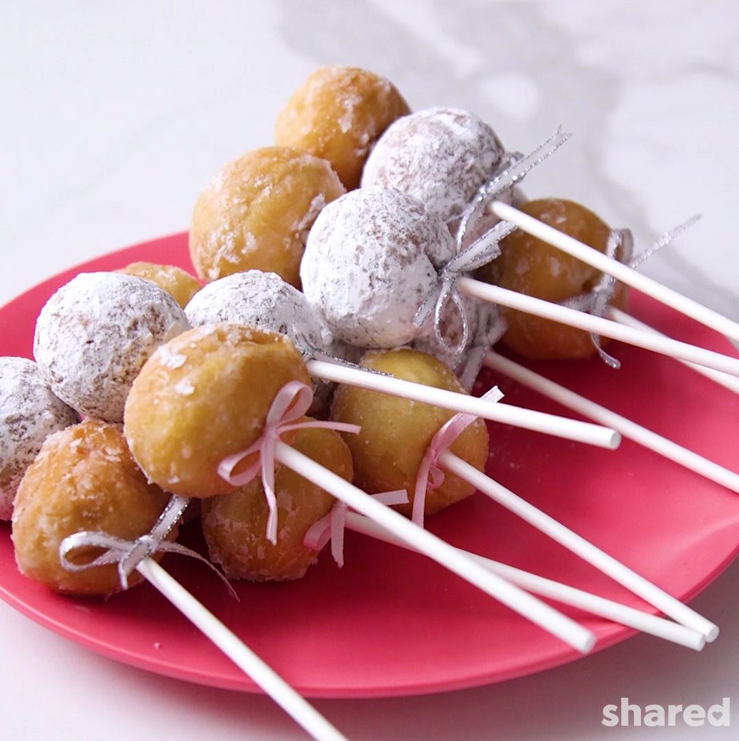 double donut holes on cake pop sticks with pink ribbon bows