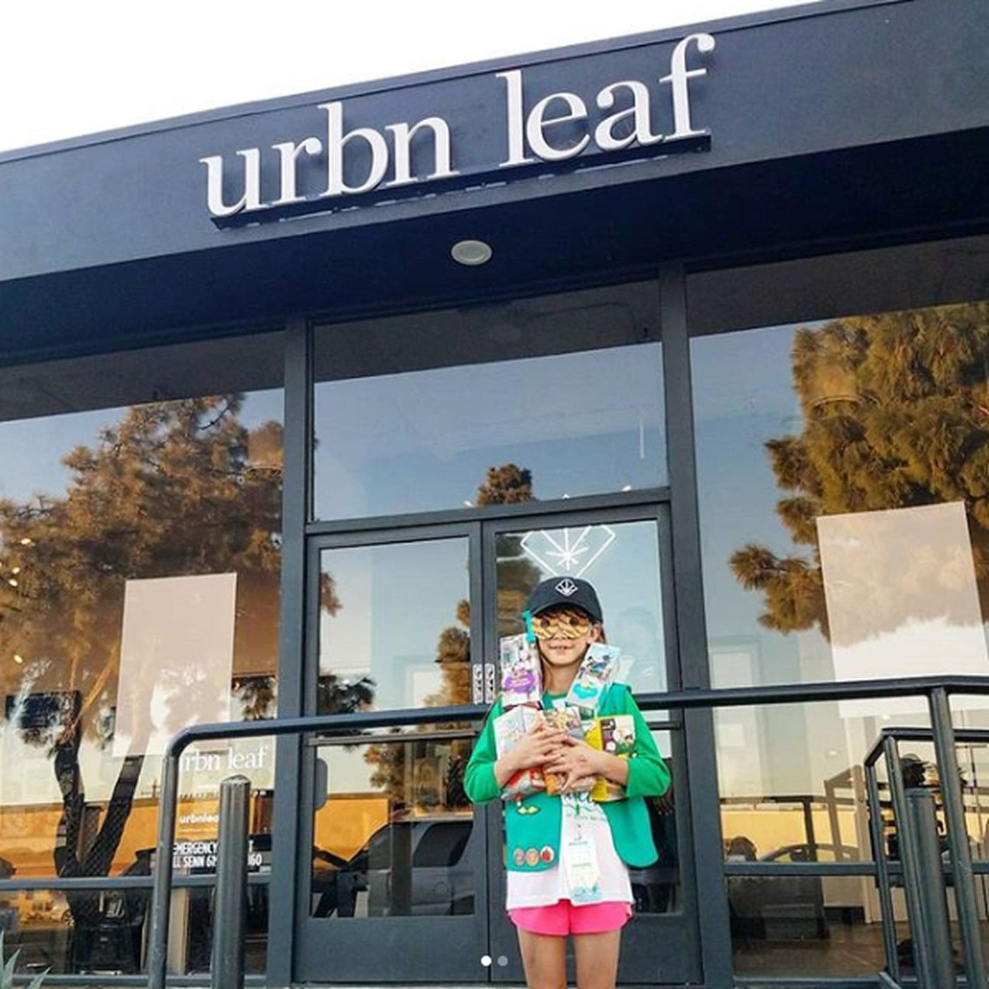 Girl scout selling cookies outside marijuana store
