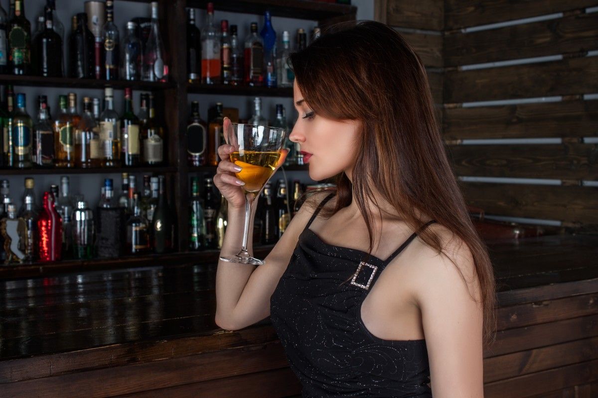 Woman drinking at a bar