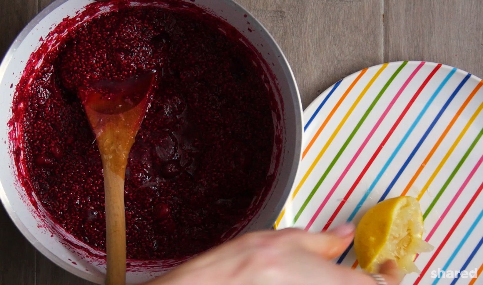 lemon on a plate with a suacepan of cranberry chia jam