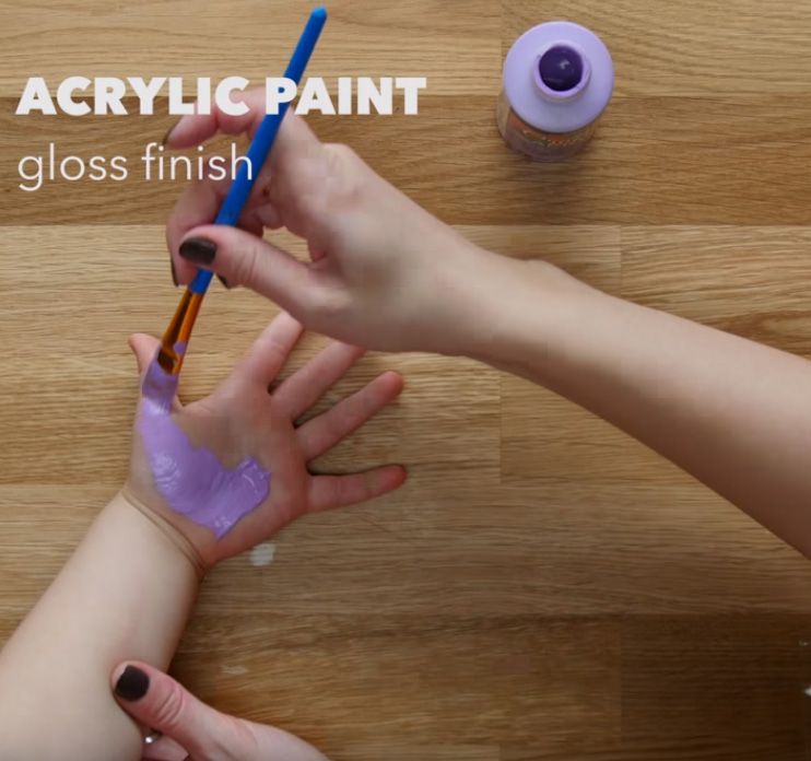 Purple acrylic paint on a child's palm handprint keychain craft