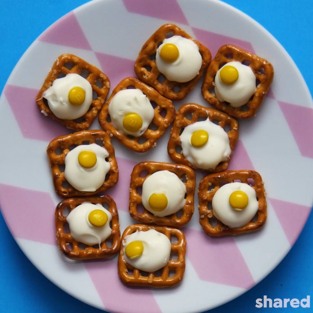 waffles pretzels topped with white chocolate and mini yellow M&Ms  