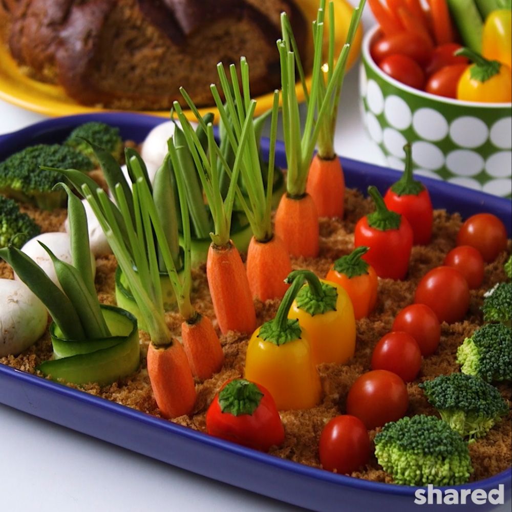 Hummus Vegetable Garden full of carrots, peppers, broccoli, mushrooms 