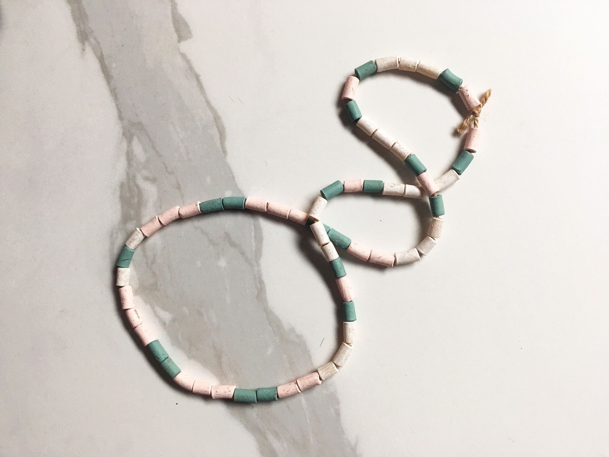 Image may contain a kids necklace made of green, pastel pink and white tubetti pasta 