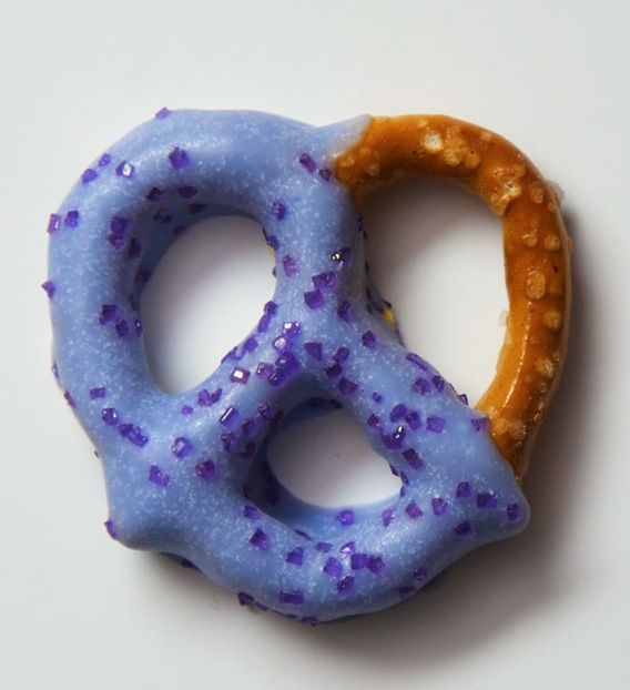 mini pretzel half coated in light purple chocolate coating with purple sprinkles