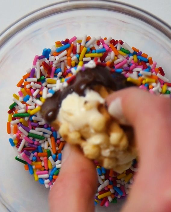 mini ice cream sandwich being dipped in sprinkles
