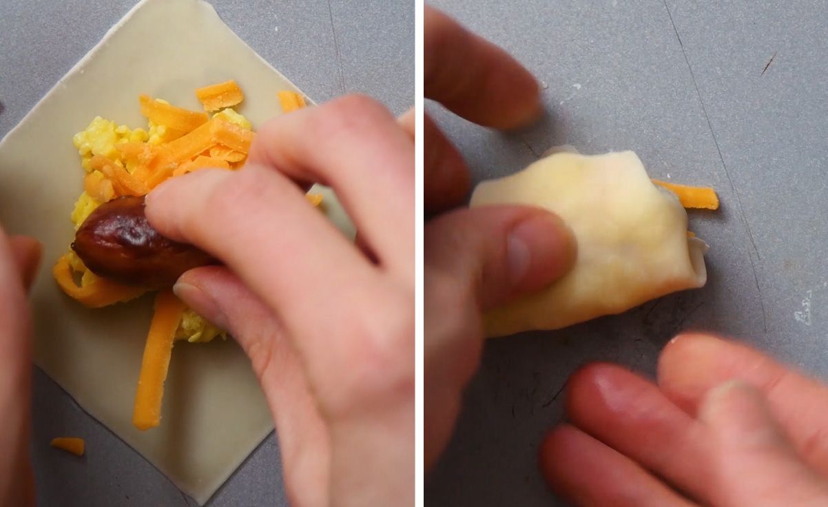 uncooked wonton wrapper being filled with a cocktail sausage and wrapped up