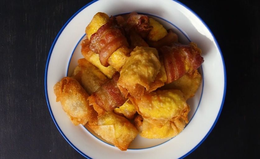 fried golden breakfast wontons stacked on a serving plate