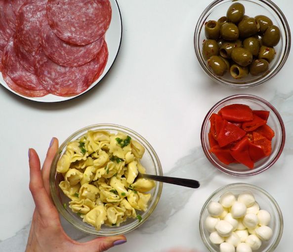 prepared antipasto ingredients in glass bowls