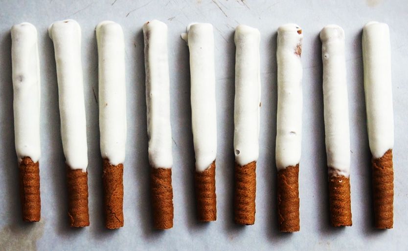 white chocolate wafer sticks lined up on a baking sheet