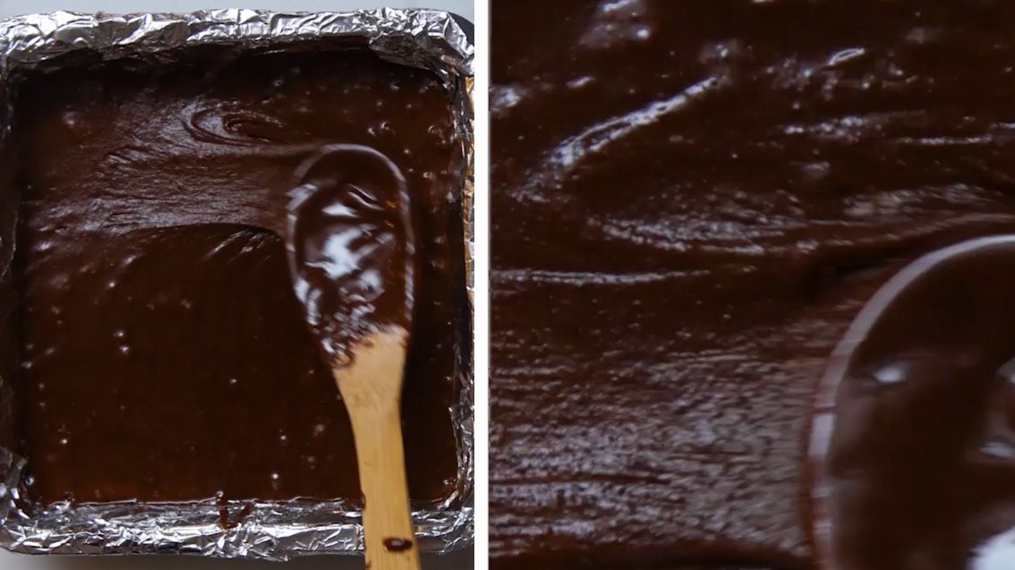 brownie batter being spread into a pan 