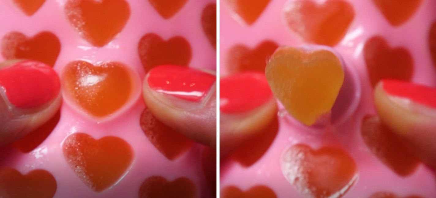 magnesiium gummie being popped out of a pink silicone mold