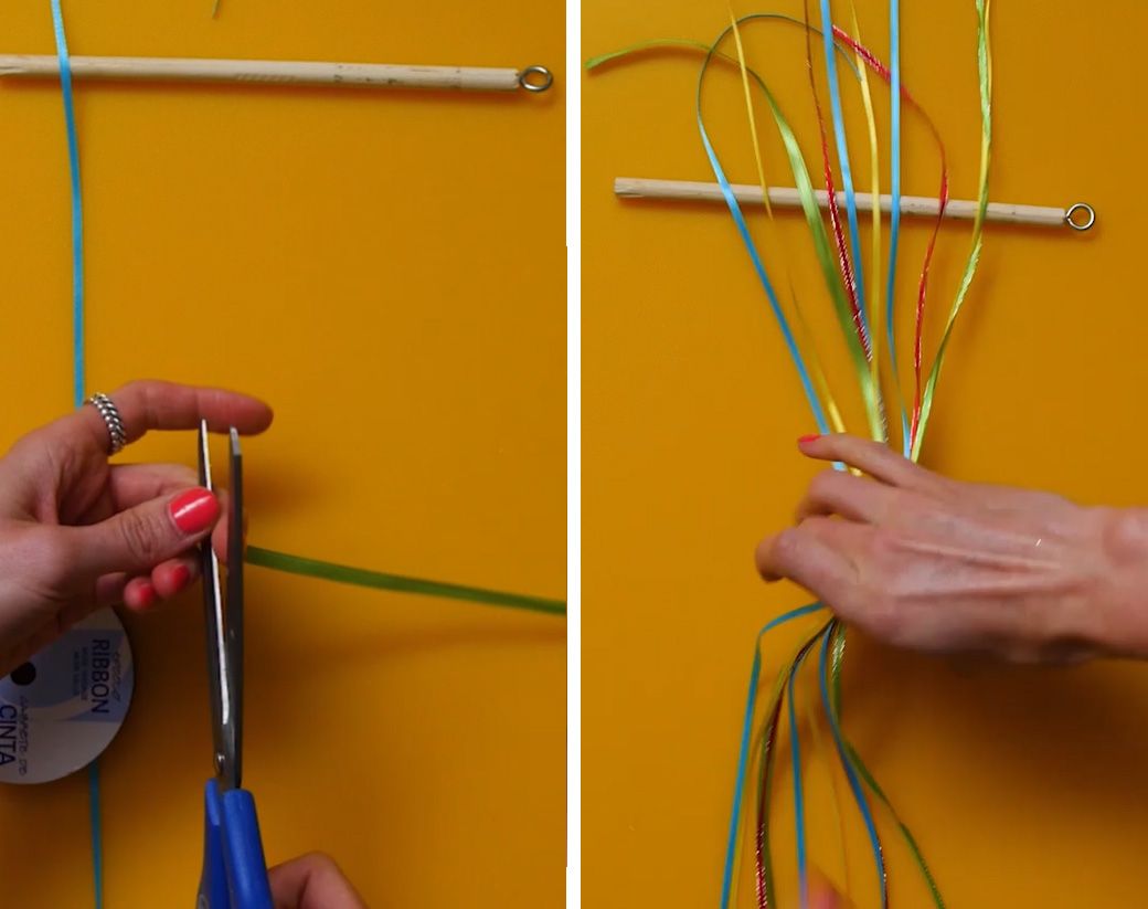 thin green, red, blue and yellow ribbon being cut