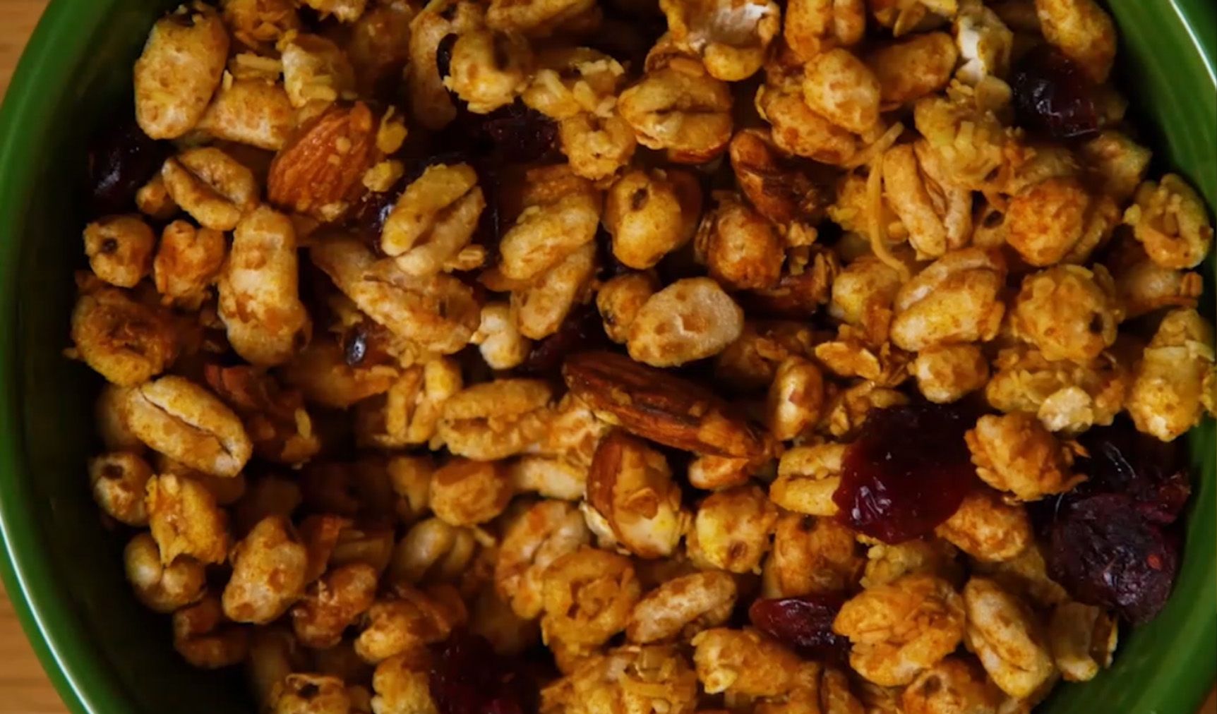 close up of turmeric granola in a green bowl